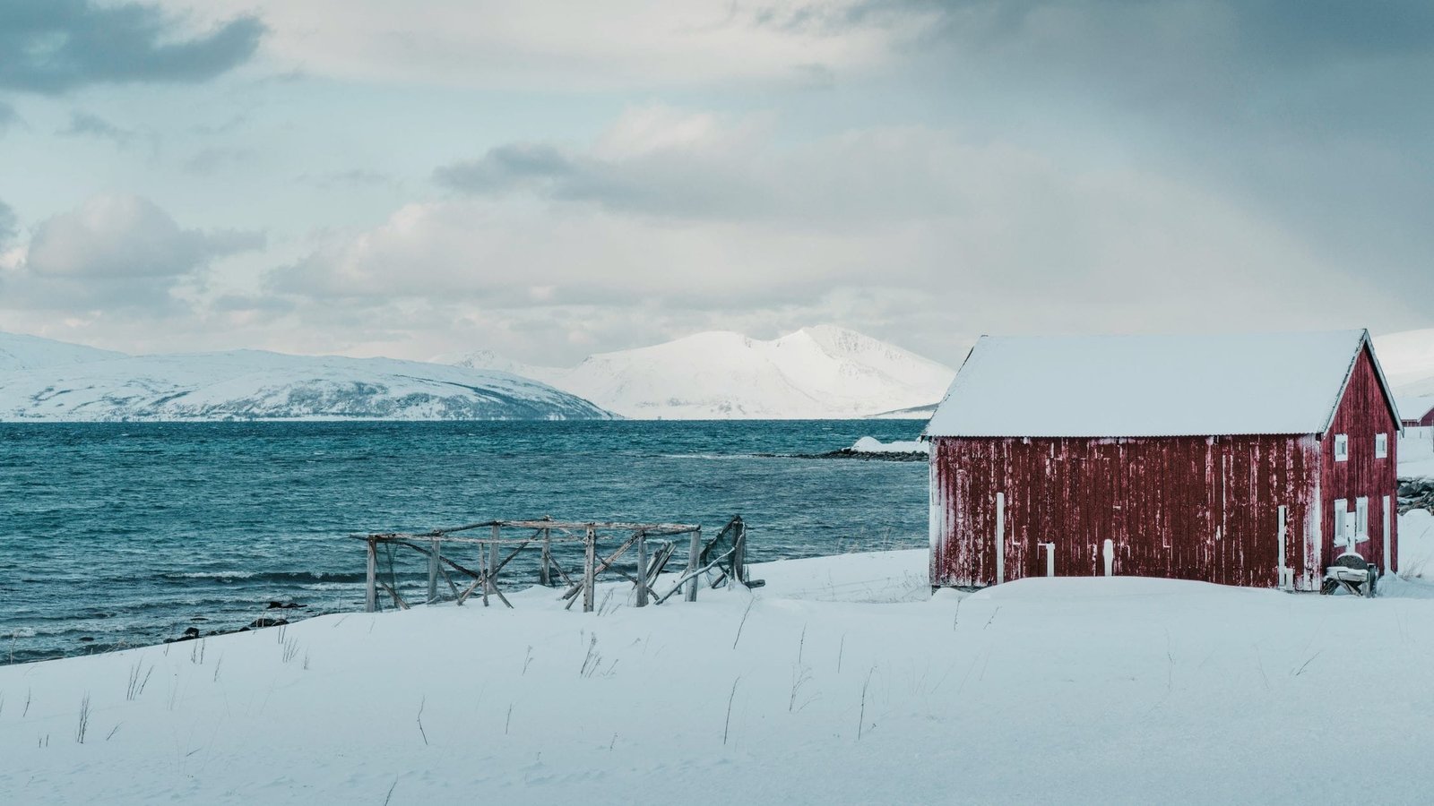 Cozy cabin near a lake surrounded by snow, HVAC tips and insights.